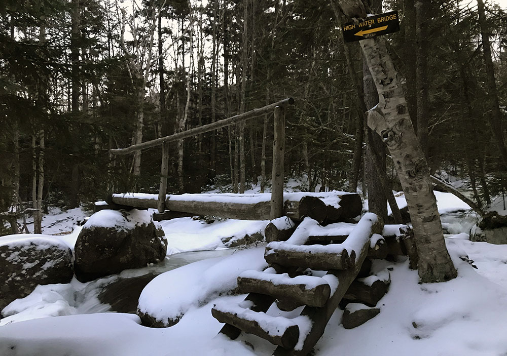 Snow blankets a bridge across Phelps Brook along the Van Hoevenberg on an early morning hike to Tabletop Mountain.