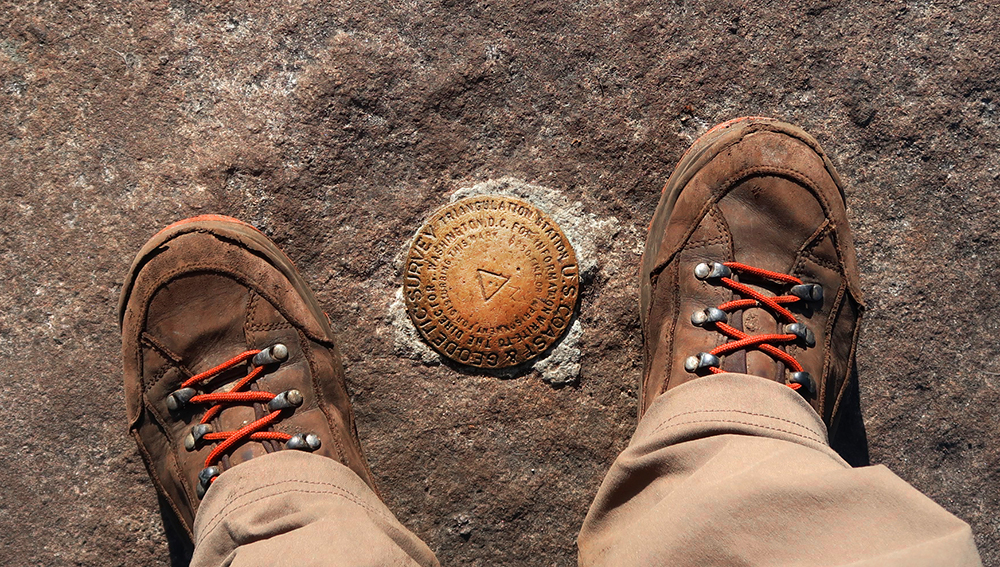 A boot photo with the survey pin atop Rocky Peak Ridge.