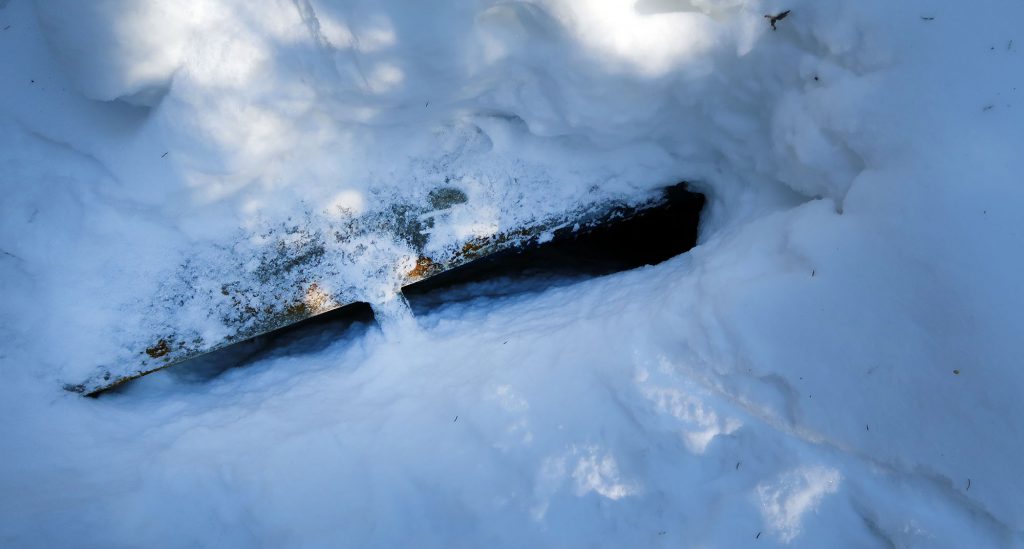 The metal body of a small aircraft wreckage was just barely visible beneath the snowpack en route to Mount Marshall via Cold Brook pass.