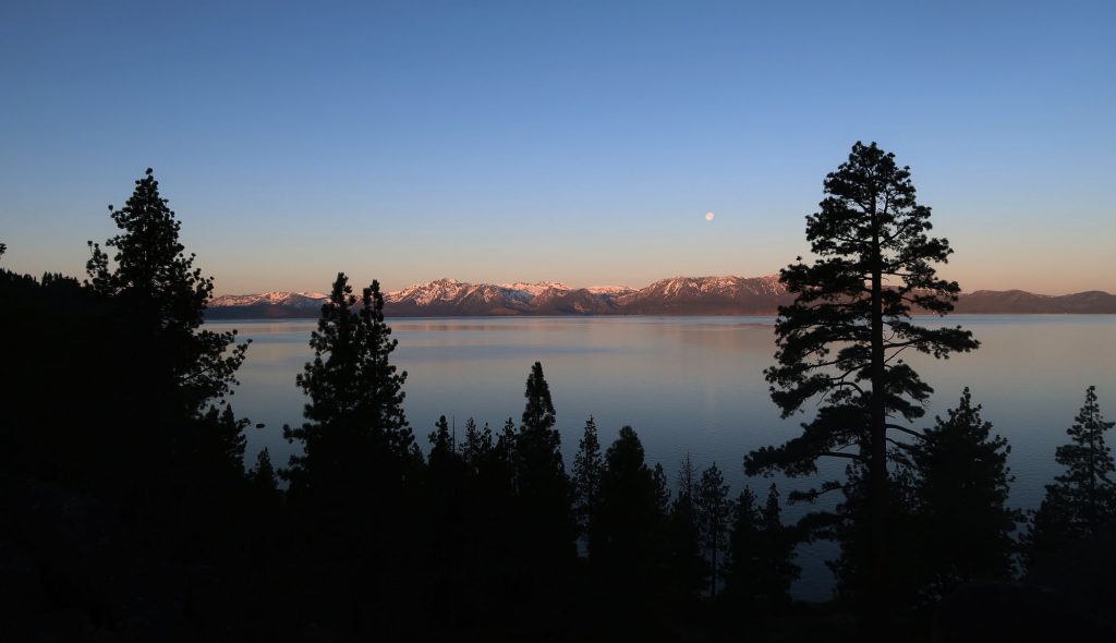 A setting moon over Lake Tahoe at sunrise, seen from US 50 en route to California.
