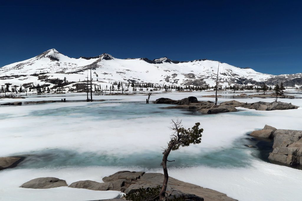 Bare summits surround Lake Aloha, a vast, rocky lake/reservoir in the Desolation Wilderness.