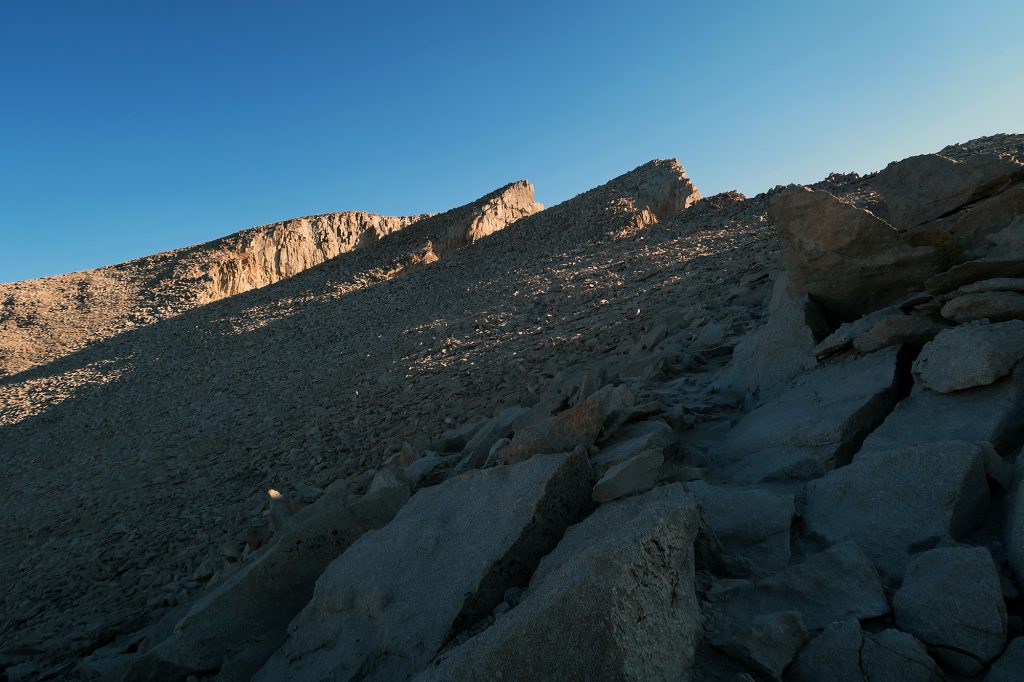 Slopes of jagged boulders, with Mount Whitney's true summit near at hand.
